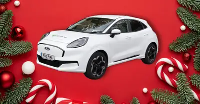 White Ford Puma on a red background with festive greenery on the edges of the image