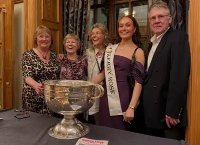 Guests at the dance standing with the Sam Maguire