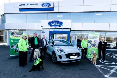 Group photo taken in the forecourt with a Ford Puma