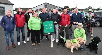 Group shot of HM&V staff and IGD volunteers and dogs