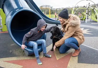 Mum Trish, son Conor and Assistance Dog Quelda at the park